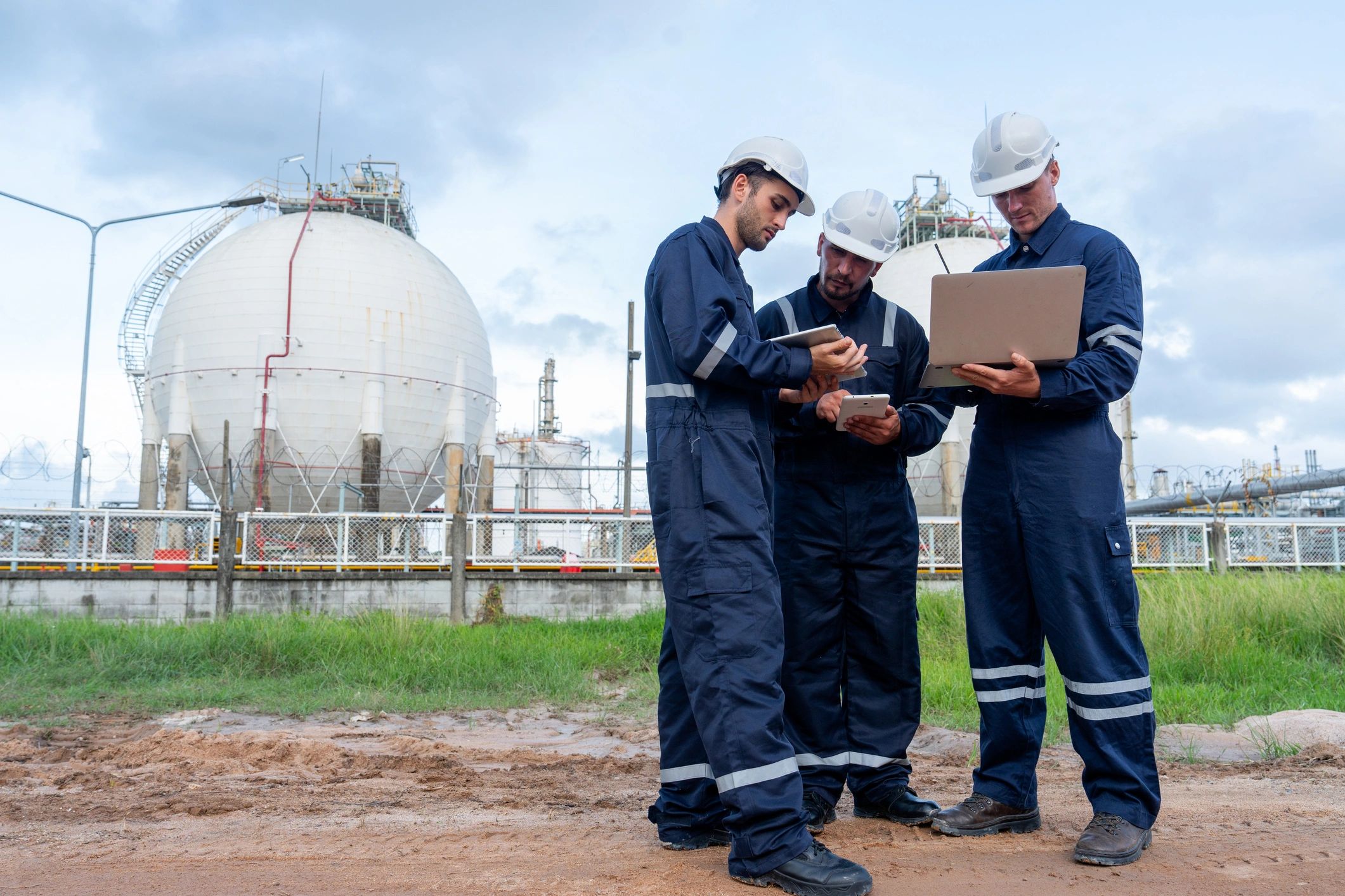 Engineering team reviewing plans at an industrial field site